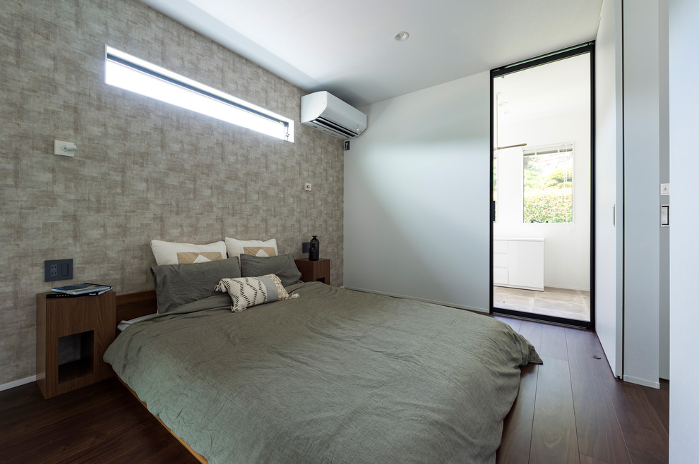 Photo of an asian master bedroom in Other with white walls, dark hardwood floors and brown floor.