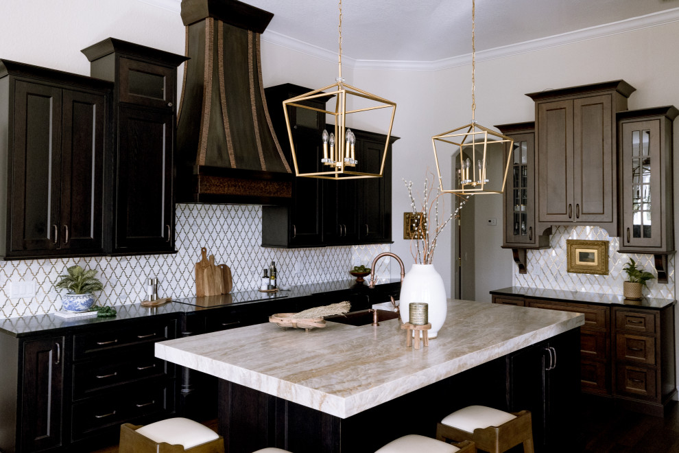 This is an example of a large traditional u-shaped eat-in kitchen in Orlando with beaded inset cabinets, dark wood cabinets, soapstone benchtops, white splashback, mosaic tile splashback, with island, black benchtop, a single-bowl sink, stainless steel appliances, medium hardwood floors and brown floor.