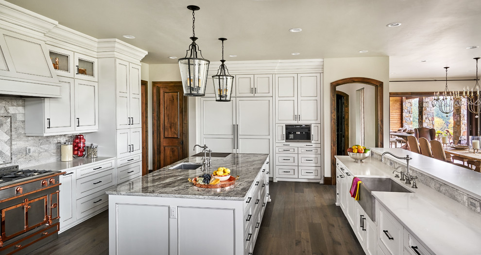 This is an example of a large country kitchen pantry in Portland with a single-bowl sink, open cabinets, white cabinets, quartz benchtops, white splashback, stone tile splashback, panelled appliances, medium hardwood floors and multiple islands.