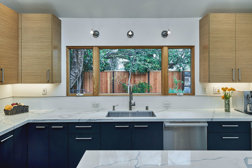 Mid-sized contemporary u-shaped separate kitchen in San Francisco with an undermount sink, flat-panel cabinets, light wood cabinets, marble benchtops, white splashback, glass sheet splashback, stainless steel appliances, slate floors, with island, grey floor and white benchtop.
