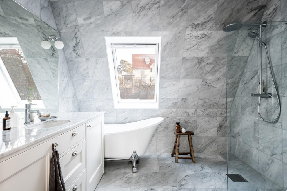 Inspiration for a scandinavian bathroom in Stockholm with recessed-panel cabinets, white cabinets, a claw-foot tub, a curbless shower, gray tile, grey floor, an open shower, grey benchtops, a single vanity and a built-in vanity.