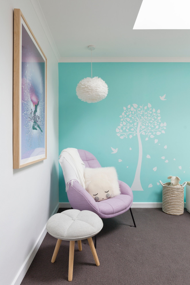 This is an example of a medium sized modern children’s room for girls in Sydney with blue walls, carpet, grey floors and a drop ceiling.