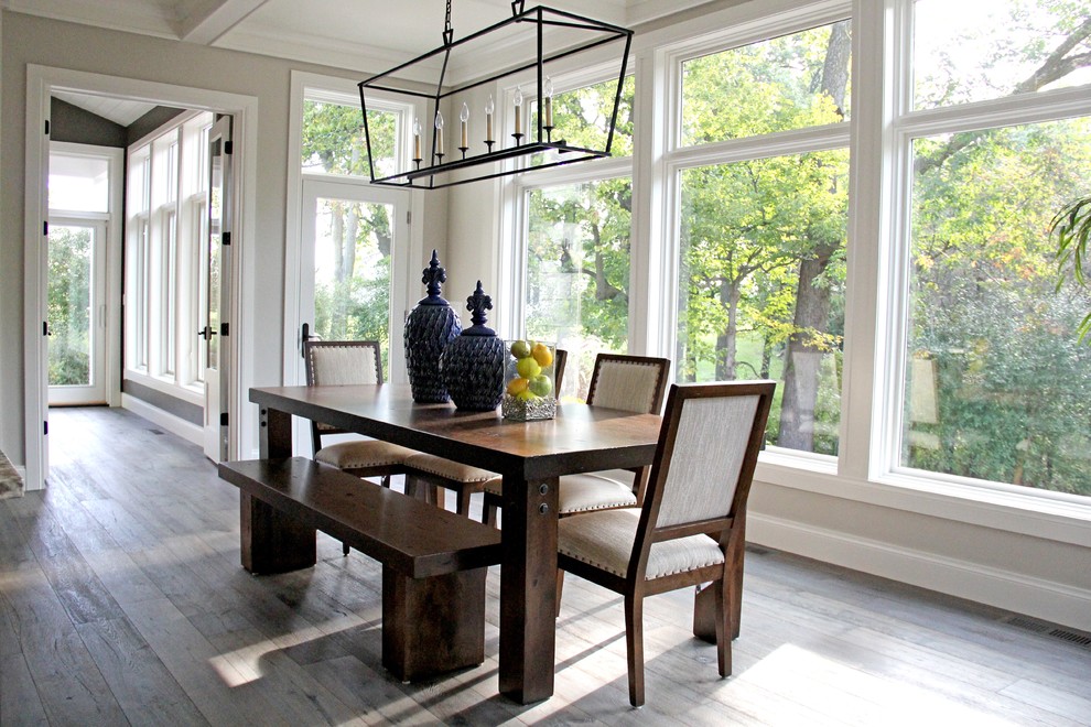 Inspiration for a large light wood floor and brown floor kitchen/dining room combo remodel with beige walls and no fireplace