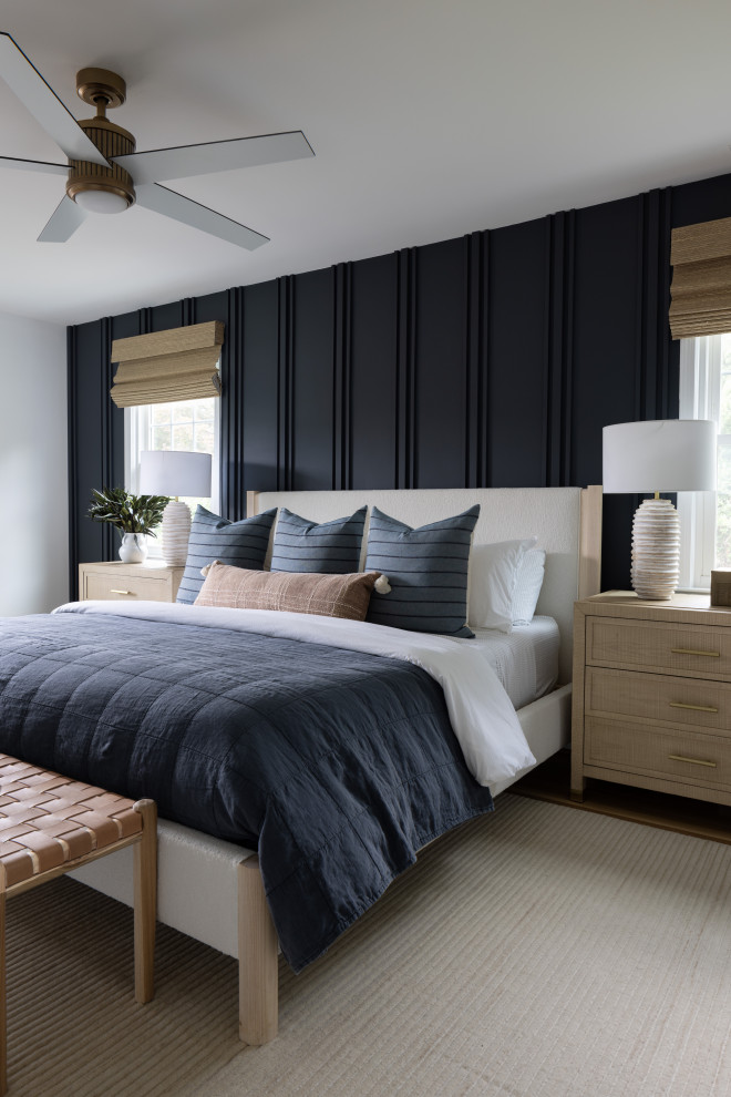 Inspiration for a mid-sized modern master bedroom in DC Metro with blue walls, light hardwood floors, a standard fireplace, beige floor and panelled walls.