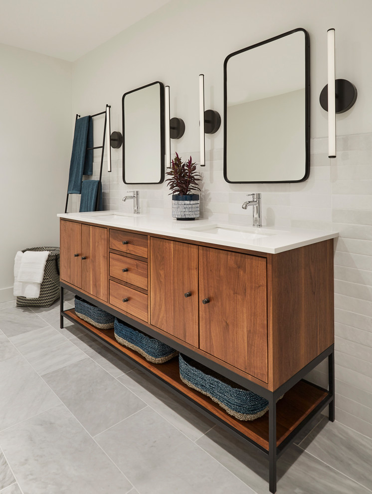 Design ideas for a mid-sized contemporary master bathroom in Chicago with flat-panel cabinets, medium wood cabinets, white tile, ceramic tile, white walls, marble floors, an undermount sink, engineered quartz benchtops, white benchtops, a double vanity, a freestanding vanity and grey floor.