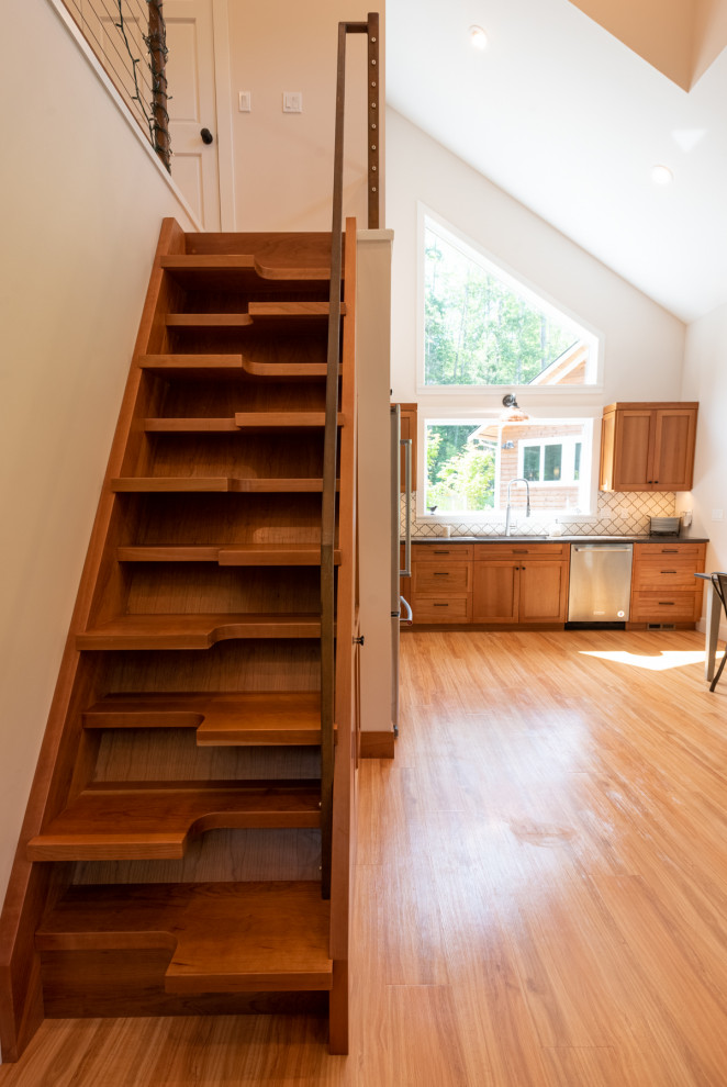 Photo of a small nautical wood straight metal railing staircase in Seattle with wood risers.