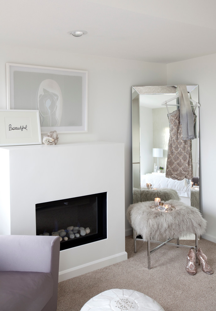 This is an example of a mid-sized transitional master bedroom in Vancouver with white walls, carpet, a standard fireplace and a plaster fireplace surround.