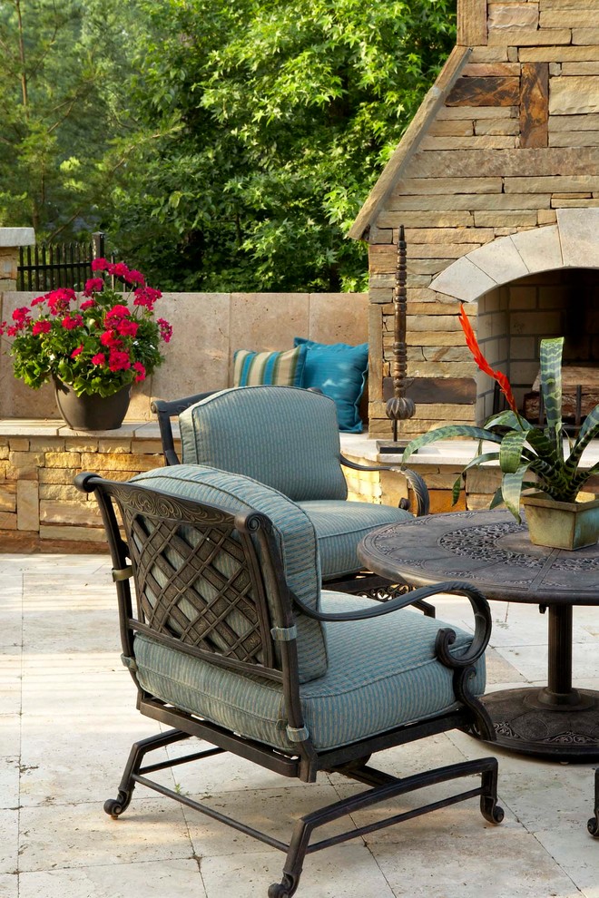 Design ideas for a mid-sized contemporary backyard patio in New Orleans with with fireplace, tile and no cover.