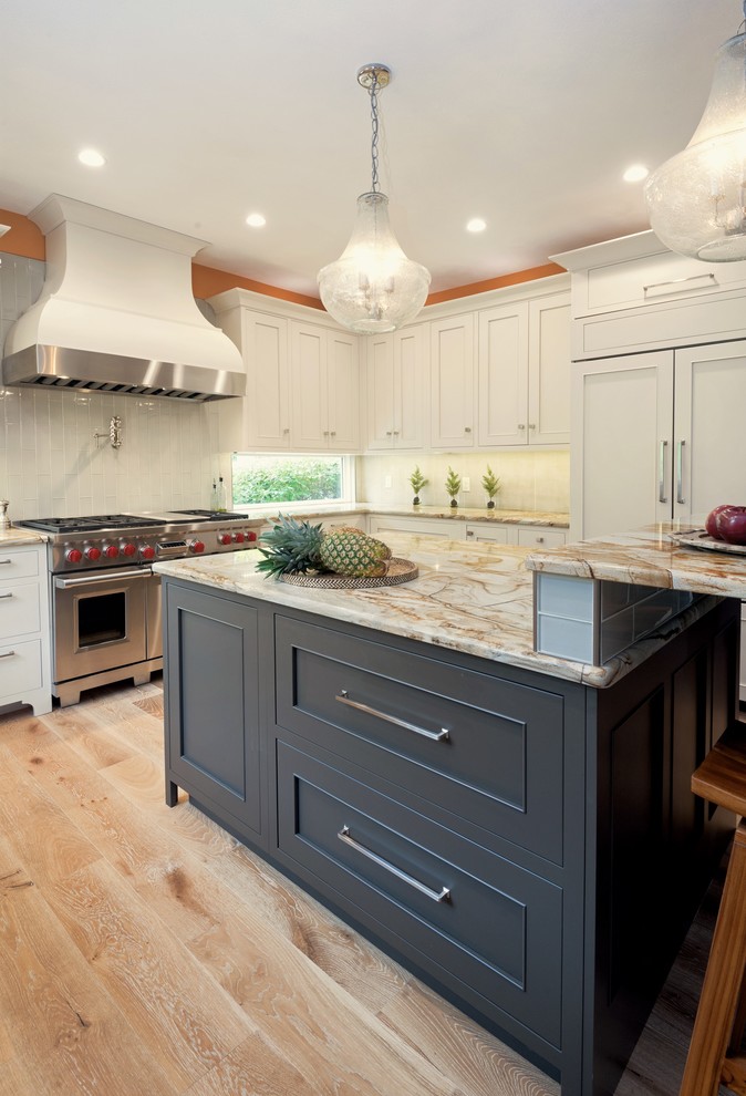 Open concept kitchen - mid-sized transitional u-shaped light wood floor and beige floor open concept kitchen idea with an undermount sink, recessed-panel cabinets, gray cabinets, granite countertops, stainless steel appliances, an island, white backsplash and glass tile backsplash