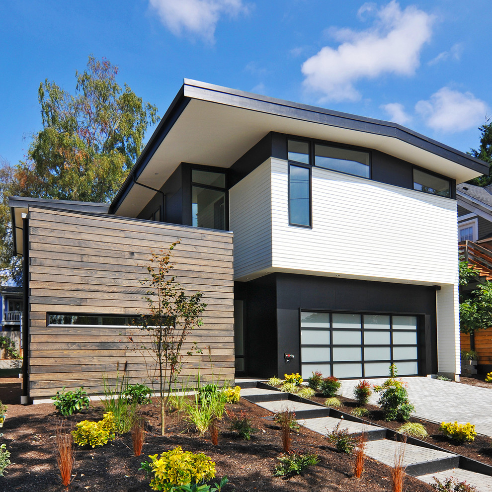 This is an example of a large midcentury two-storey multi-coloured house exterior in Seattle.