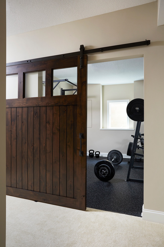 Large traditional home weight room in Minneapolis with grey walls.