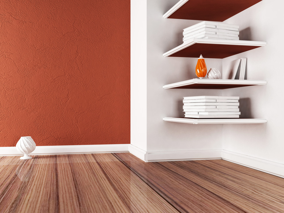 Example of a mid-sized medium tone wood floor basement design in Minneapolis with orange walls