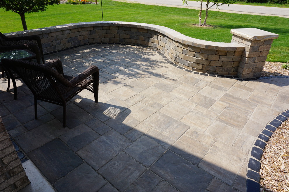 This is an example of a small traditional front yard patio in Other with concrete pavers and no cover.