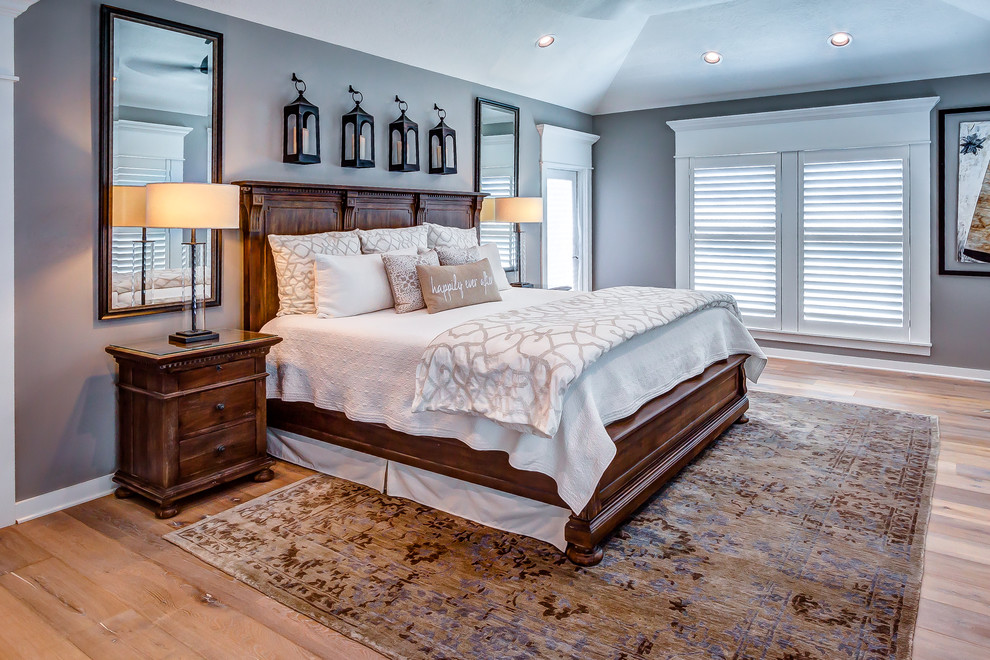 Inspiration for a large transitional master bedroom in Houston with grey walls, medium hardwood floors and no fireplace.