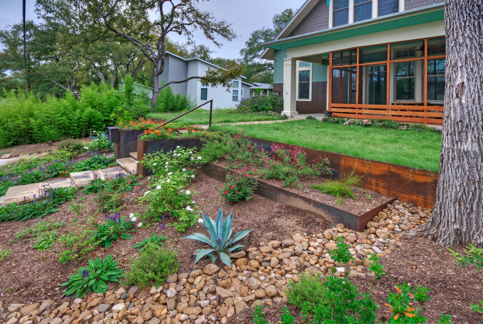 This is an example of a large contemporary front yard xeriscape in Austin.