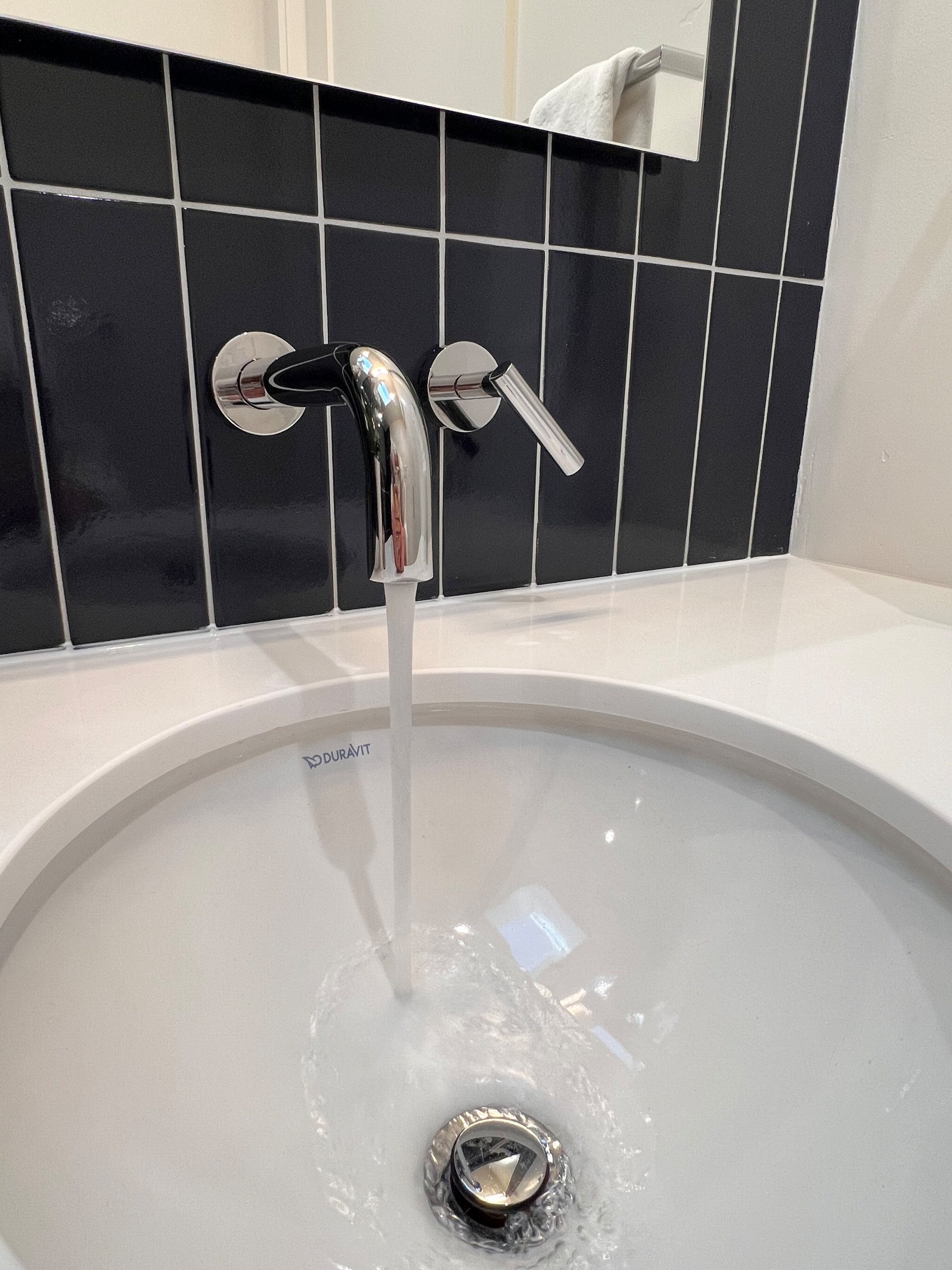 A Wall Mounted Faucet Adds to the Modern Spacious Design