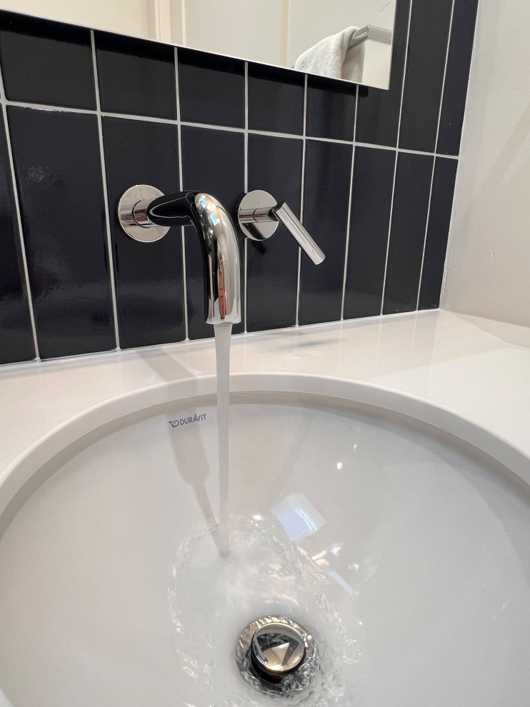 Inspiration for a small contemporary glass tile ceramic tile and white floor powder room remodel in Sacramento with flat-panel cabinets, white cabinets, white countertops and a floating vanity