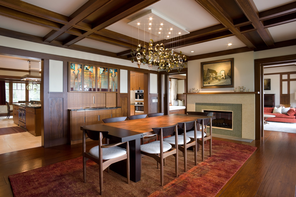Photo of a transitional dining room in Chicago with white walls, dark hardwood floors and a ribbon fireplace.
