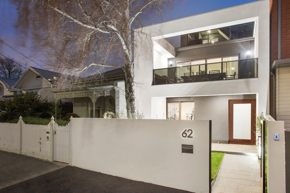Contemporary two-storey white house exterior in Melbourne with a flat roof.
