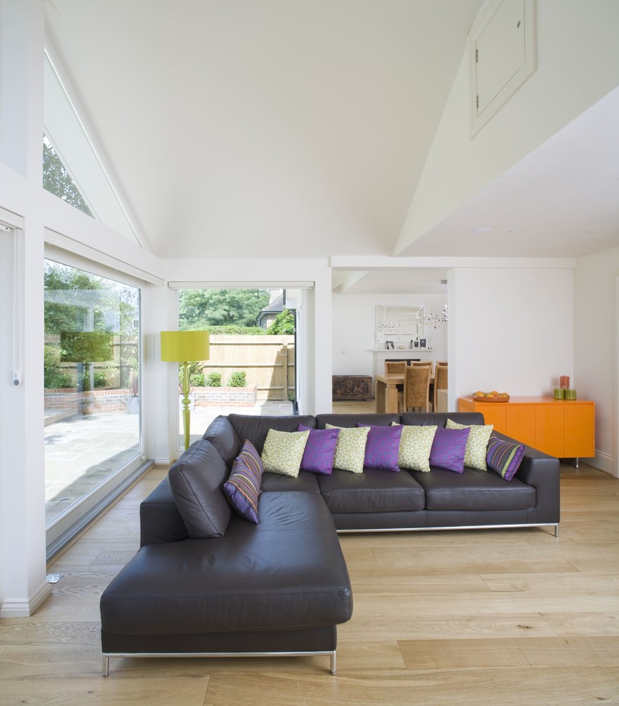 This is an example of a contemporary living room in Cambridgeshire with white walls.