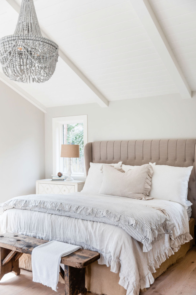 Inspiration for a mid-sized transitional master bedroom in Sacramento with white walls, light hardwood floors and beige floor.