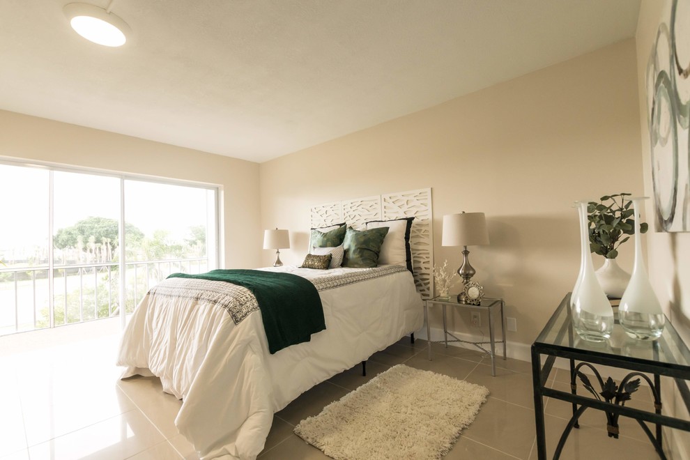 Mid-sized transitional master bedroom in Miami with beige walls, ceramic floors and beige floor.