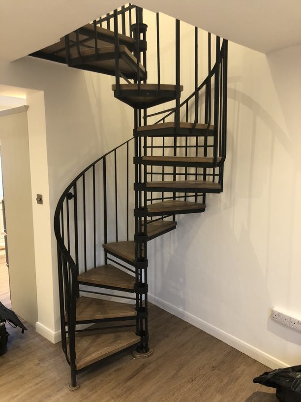 This is an example of a modern spiral staircase in Berkshire with metal railing.