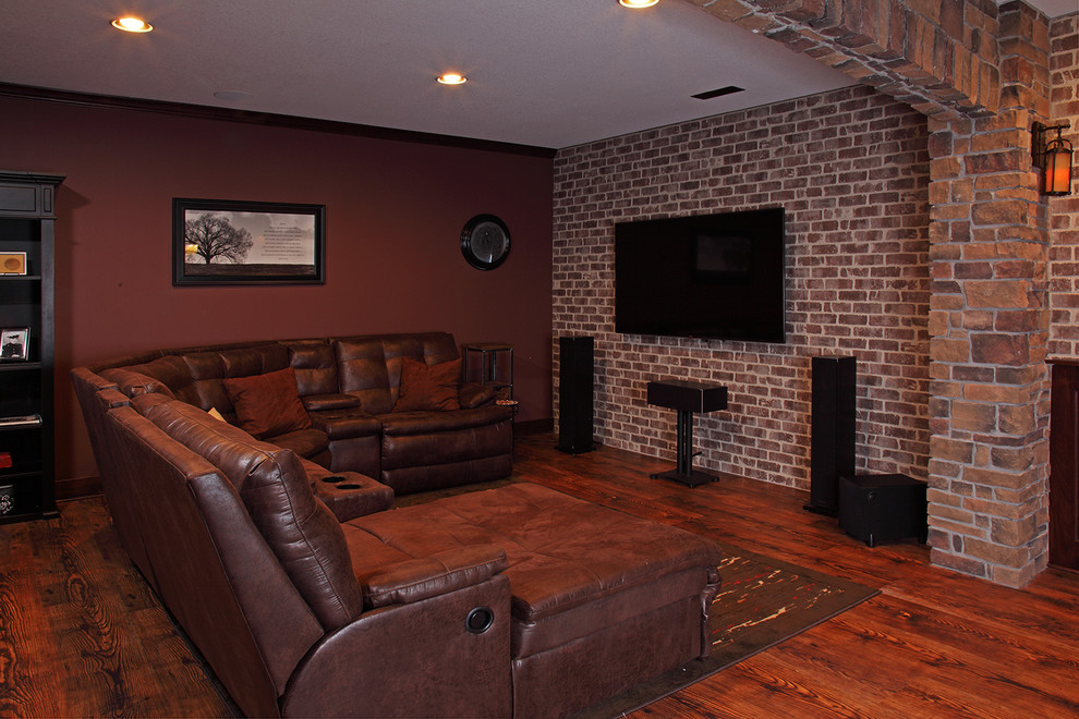 Inspiration for a mid-sized country open concept home theatre in Minneapolis with brown walls, medium hardwood floors, a wall-mounted tv and brown floor.