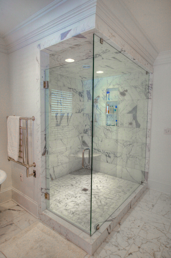 Photo of a mid-sized transitional master wet room bathroom in Charlotte with shaker cabinets, white cabinets, a freestanding tub, a two-piece toilet, gray tile, white tile, stone slab, white walls, marble floors, an undermount sink and marble benchtops.