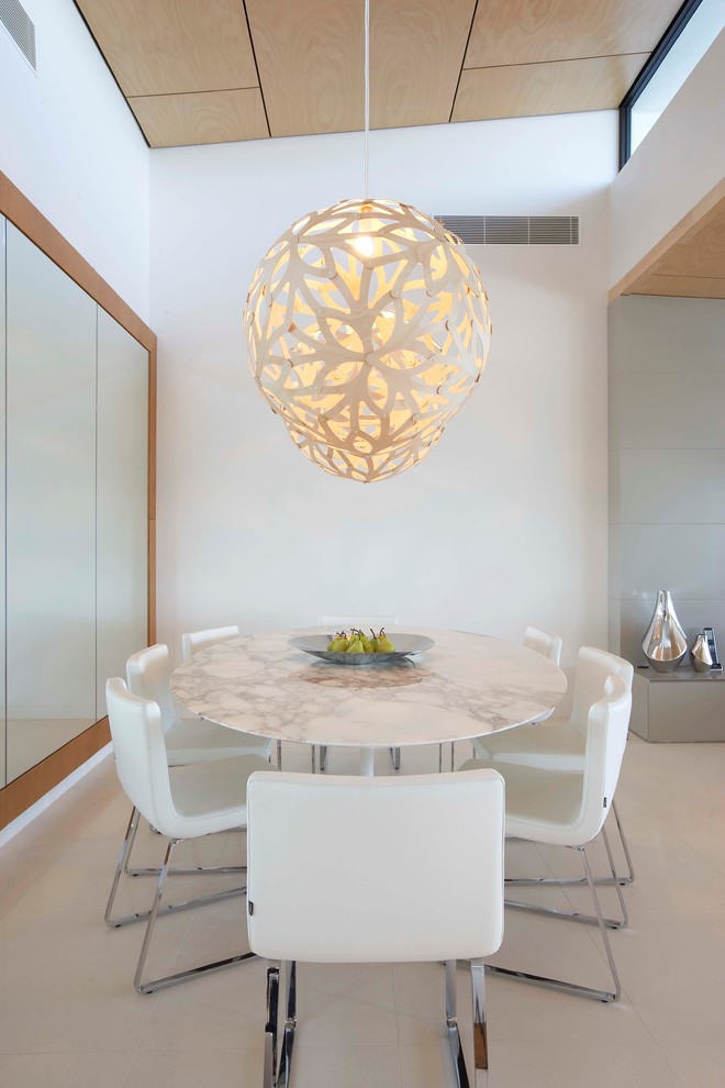 This is an example of a modern open plan dining in Brisbane with white walls.