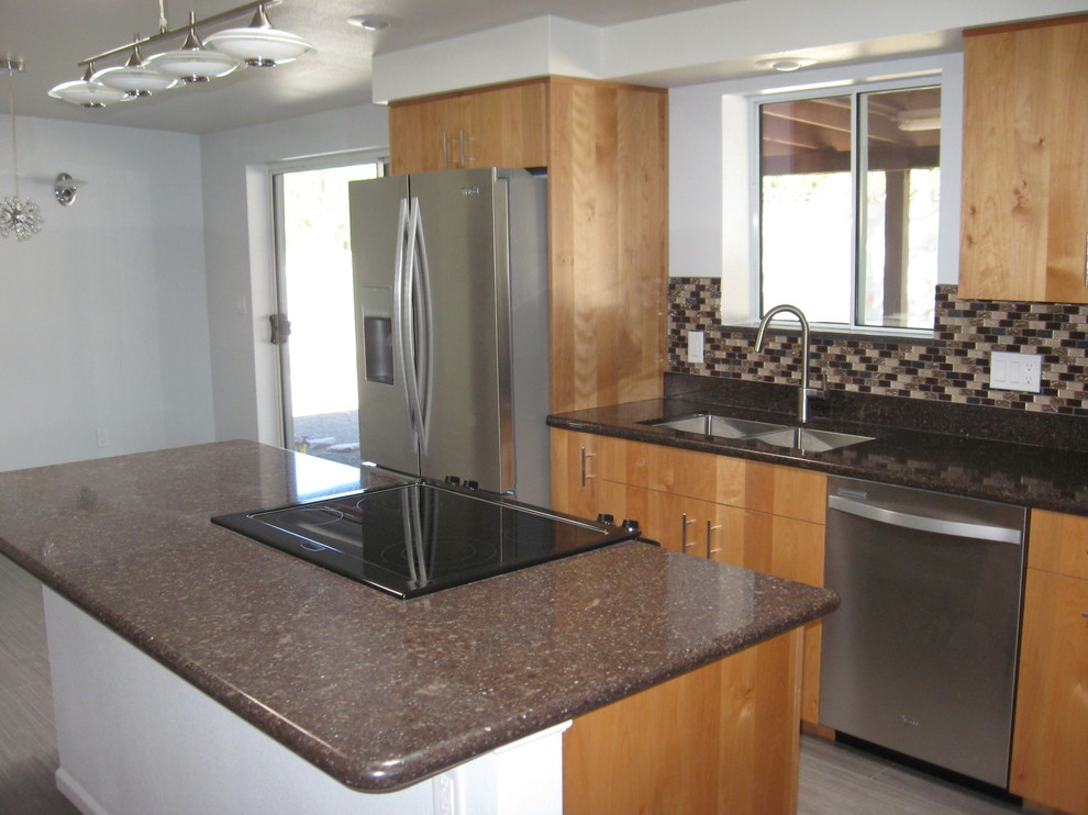 Inspiration for a mid-sized transitional galley porcelain tile and beige floor open concept kitchen remodel in Phoenix with a double-bowl sink, flat-panel cabinets, light wood cabinets, granite countertops, brown backsplash, glass tile backsplash, stainless steel appliances and an island
