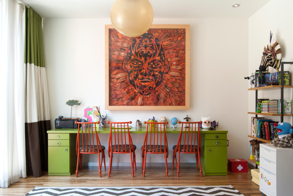 Large contemporary gender-neutral kids' study room in New York with white walls and medium hardwood floors for kids 4-10 years old.