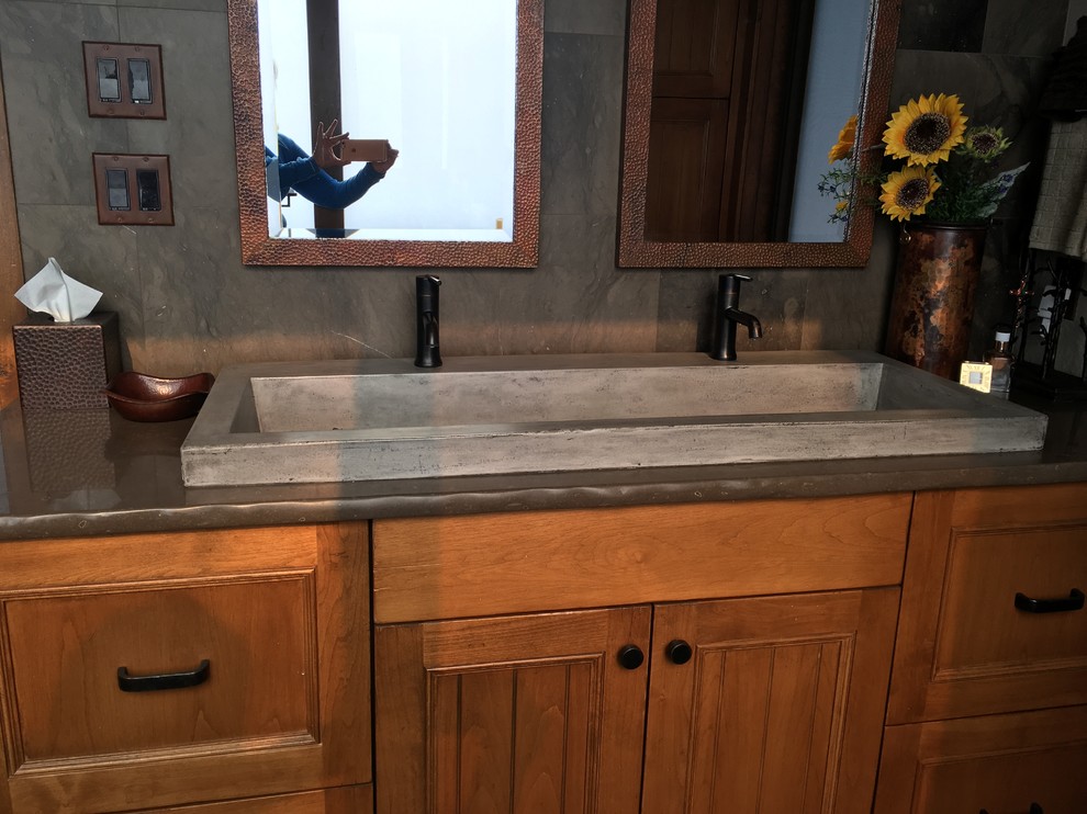 Small country master bathroom in Denver with flat-panel cabinets, distressed cabinets, a freestanding tub, an alcove shower, a one-piece toilet, brown tile, stone tile, grey walls, porcelain floors, engineered quartz benchtops and a trough sink.