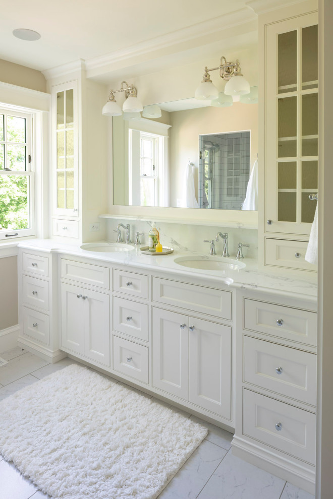 Inspiration for a mid-sized coastal master ceramic tile ceramic tile and double-sink bathroom remodel in Minneapolis with beaded inset cabinets, white cabinets, beige walls, an undermount sink, marble countertops, multicolored countertops and a built-in vanity