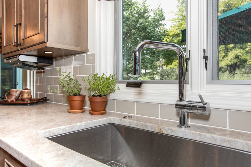 Inspiration for a mid-sized rustic galley medium tone wood floor eat-in kitchen remodel in Chicago with an undermount sink, recessed-panel cabinets, medium tone wood cabinets, marble countertops, gray backsplash, ceramic backsplash, stainless steel appliances and an island