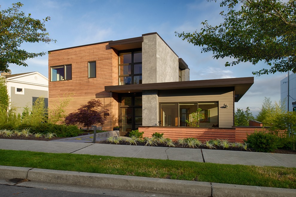 This is an example of a large modern two-storey exterior in Seattle with mixed siding and a flat roof.