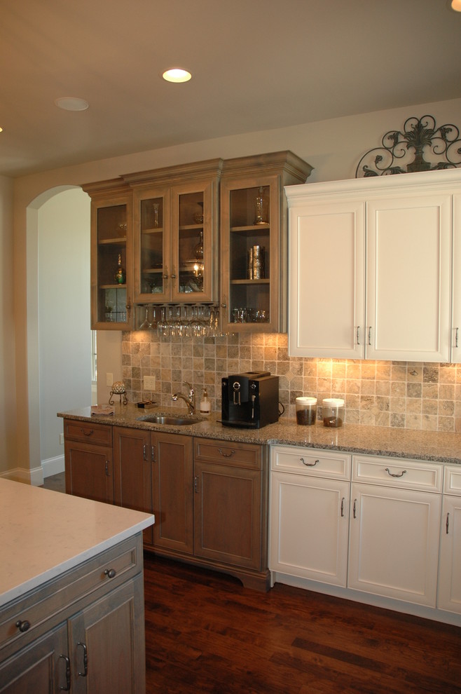 Kitchen pantry - large transitional u-shaped medium tone wood floor kitchen pantry idea with a farmhouse sink, flat-panel cabinets, yellow cabinets, laminate countertops, brown backsplash, stone tile backsplash, paneled appliances and an island