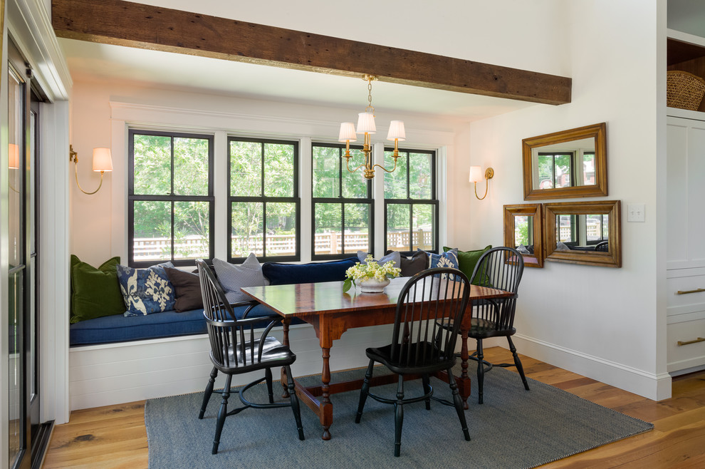 Country kitchen/dining combo in Philadelphia with white walls and medium hardwood floors.