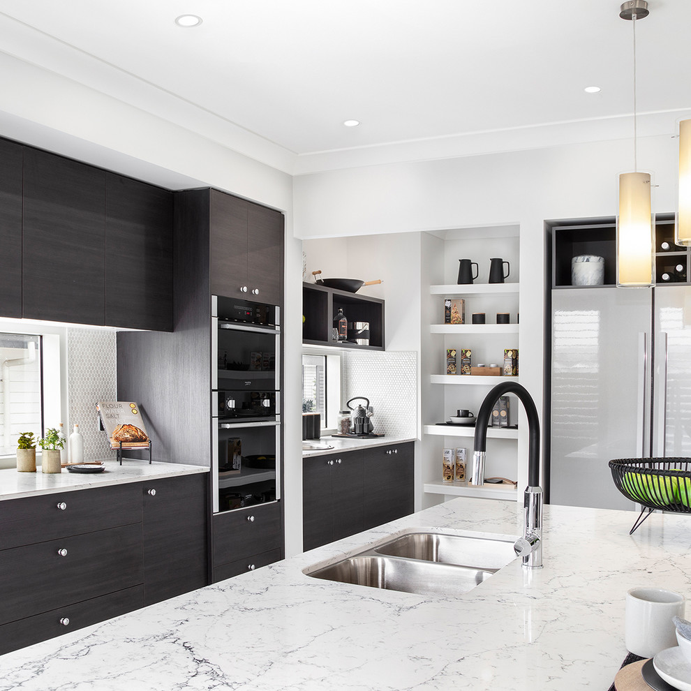 This is an example of a mid-sized contemporary galley kitchen pantry in Wollongong with an undermount sink, shaker cabinets, dark wood cabinets, marble benchtops, glass sheet splashback, black appliances, ceramic floors, with island, white floor and white benchtop.