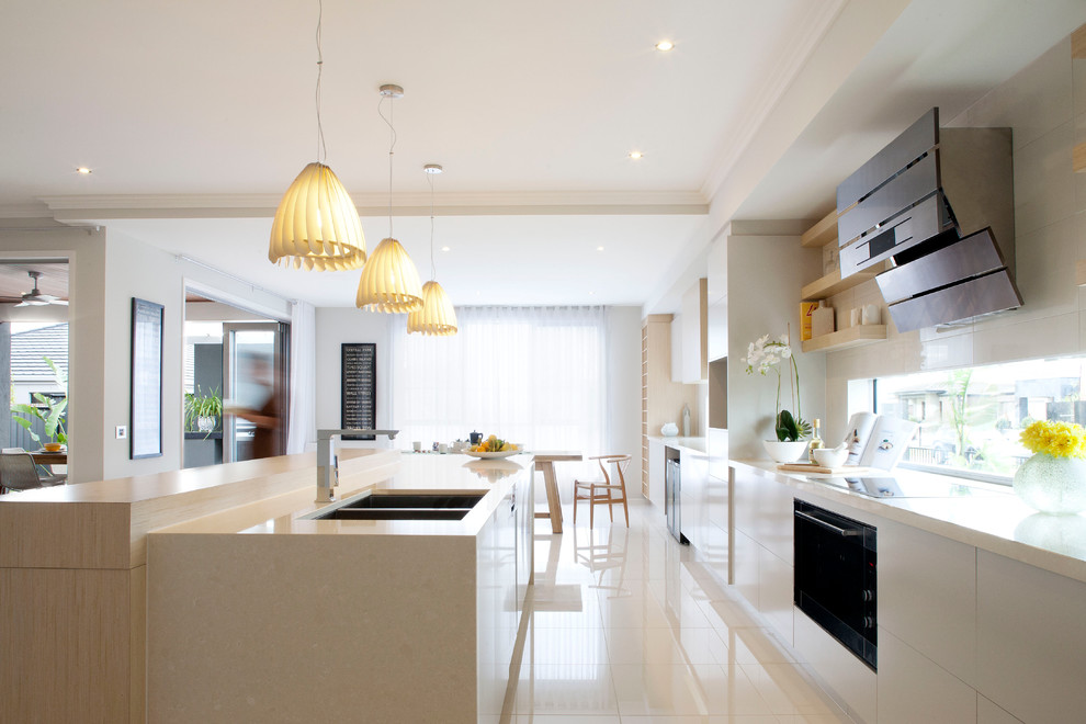 Inspiration for a mid-sized contemporary eat-in kitchen in Melbourne with flat-panel cabinets, white cabinets, an undermount sink, quartz benchtops, stainless steel appliances, ceramic floors and with island.