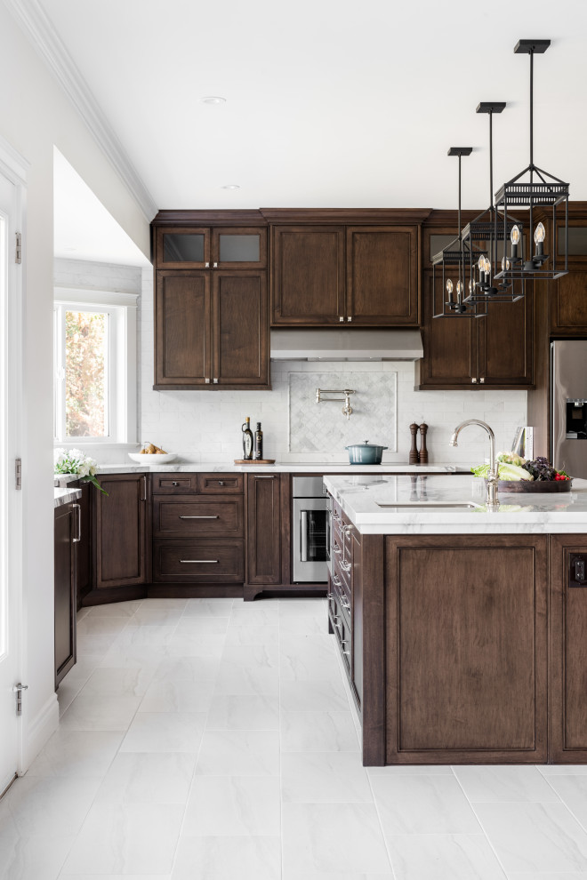 Inspiration for a large transitional u-shaped porcelain tile and white floor open concept kitchen remodel in Vancouver with an undermount sink, recessed-panel cabinets, dark wood cabinets, quartz countertops, white backsplash, ceramic backsplash, stainless steel appliances, an island and white countertops