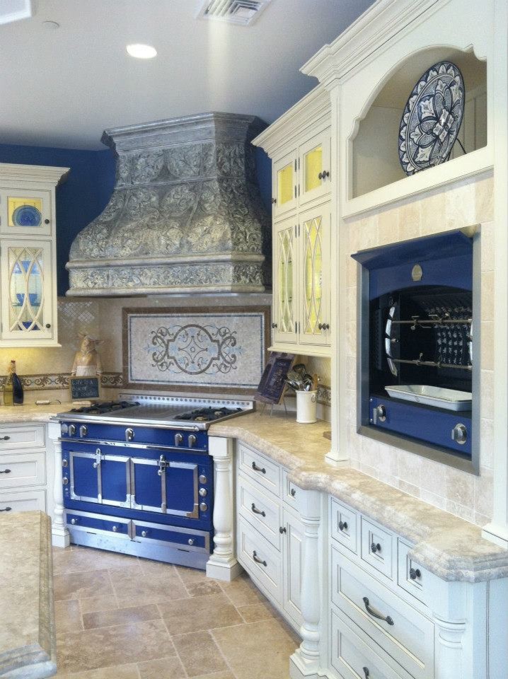 This is an example of a mid-sized traditional u-shaped eat-in kitchen in New York with an undermount sink, beaded inset cabinets, white cabinets, limestone benchtops, beige splashback, subway tile splashback, coloured appliances and travertine floors.