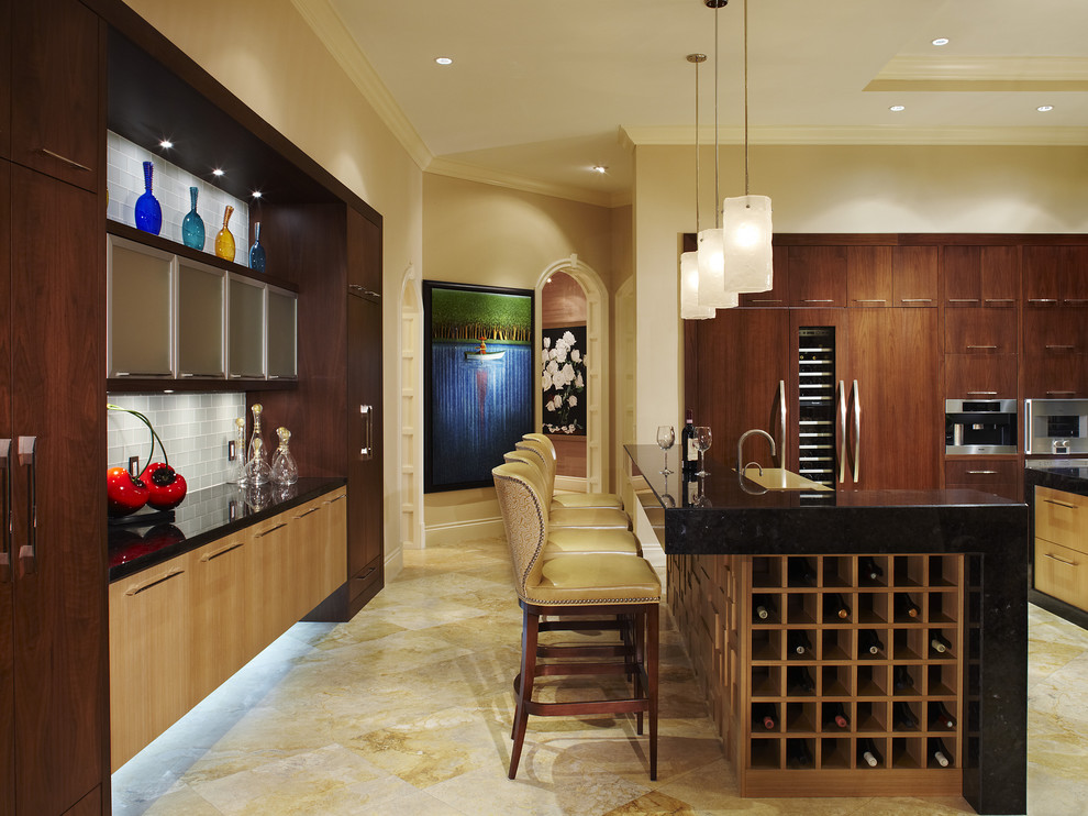 This is an example of a large contemporary u-shaped eat-in kitchen in Miami with stainless steel appliances, a drop-in sink, flat-panel cabinets, dark wood cabinets, granite benchtops, black splashback, stone slab splashback, travertine floors and with island.