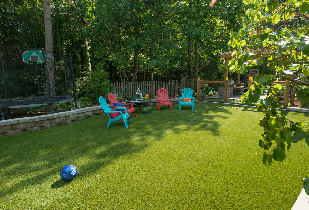 Mid-sized traditional backyard partial sun outdoor sport court in Raleigh with with outdoor playset and brick pavers.