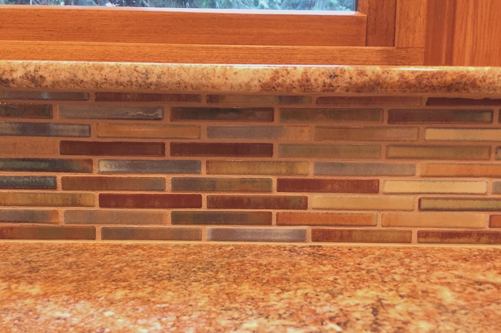 Mid-sized eclectic u-shaped medium tone wood floor and brown floor eat-in kitchen photo in Seattle with an undermount sink, shaker cabinets, medium tone wood cabinets, granite countertops, multicolored backsplash, mosaic tile backsplash, stainless steel appliances and an island