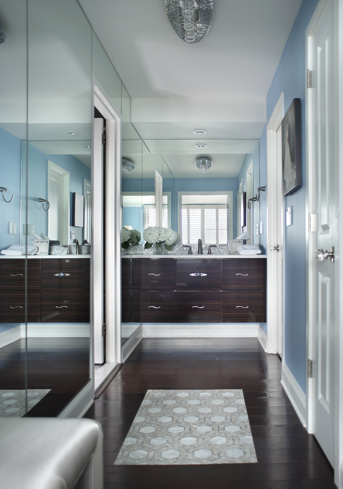 Design ideas for a small contemporary gender-neutral dressing room in Newark with flat-panel cabinets, dark wood cabinets and dark hardwood floors.
