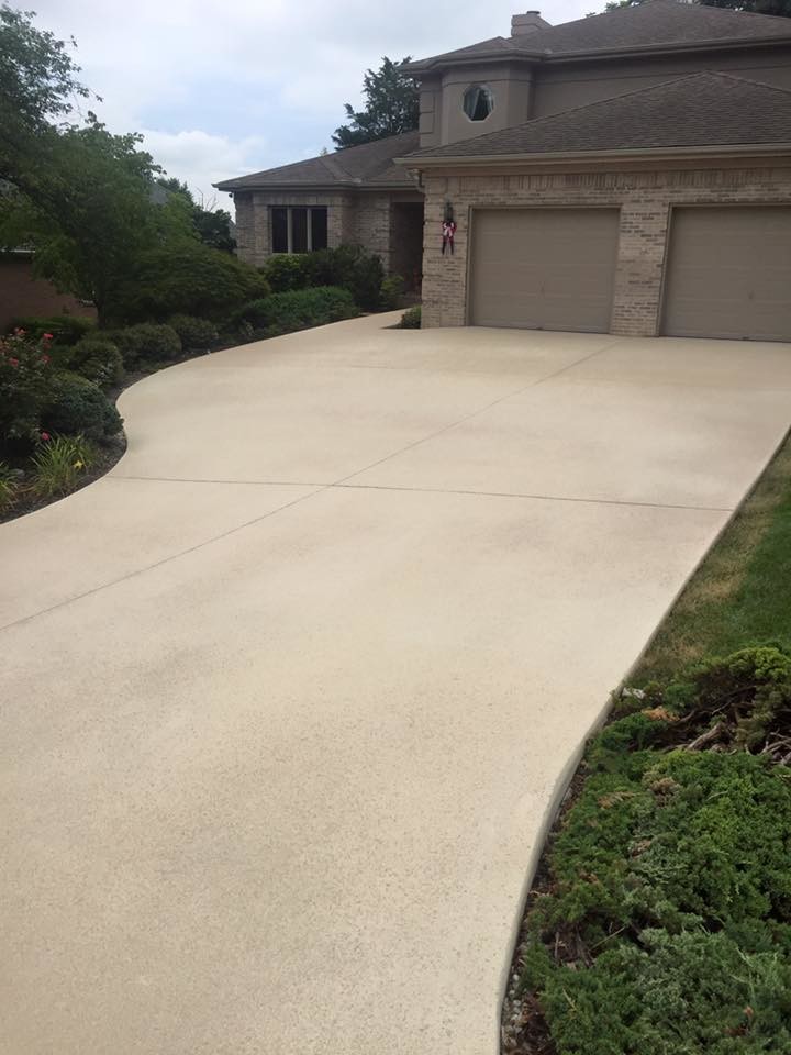 Photo of a large traditional front yard full sun driveway in Other with a garden path and concrete pavers.