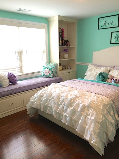 Photo of a mid-sized transitional bedroom in DC Metro with green walls and medium hardwood floors.