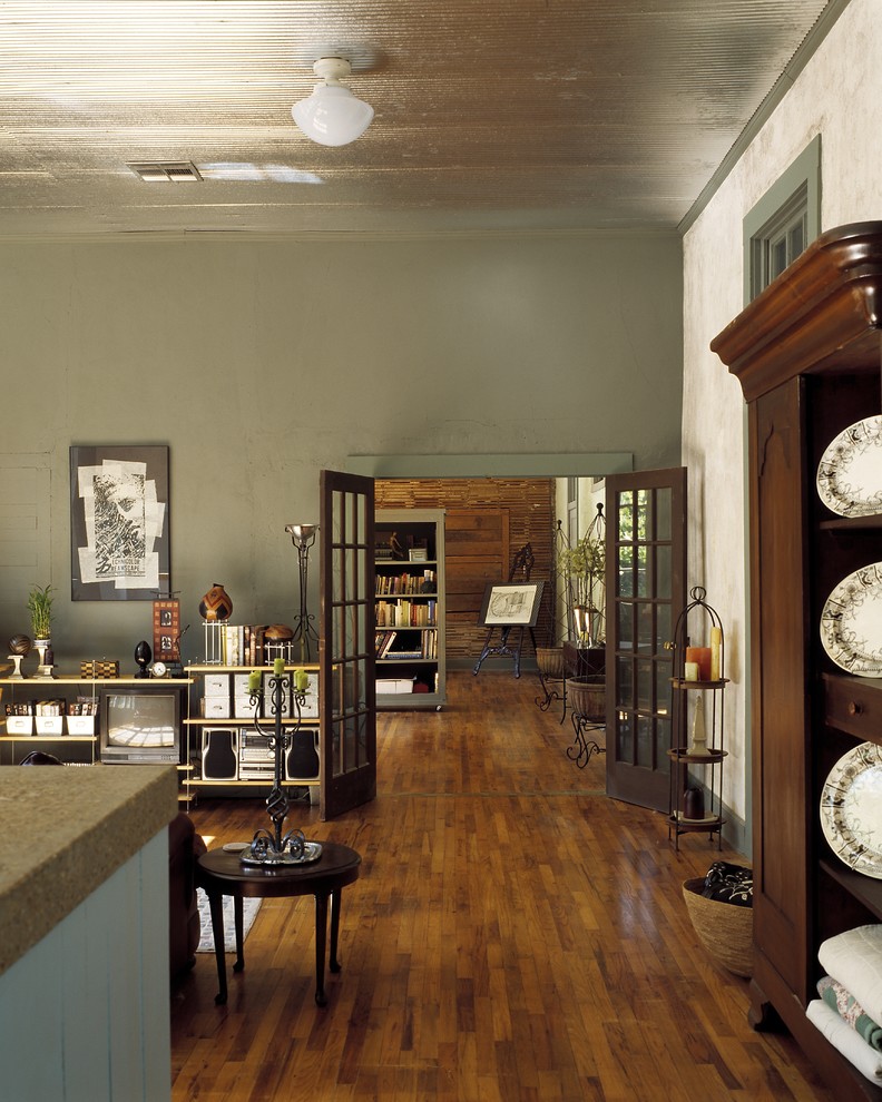 Photo of a traditional living room in Jackson with green walls and brown floor.