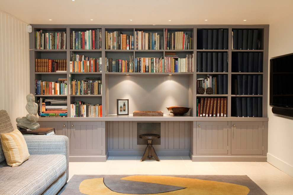Inspiration for a small traditional home office in London with a library, white walls and a built-in desk.